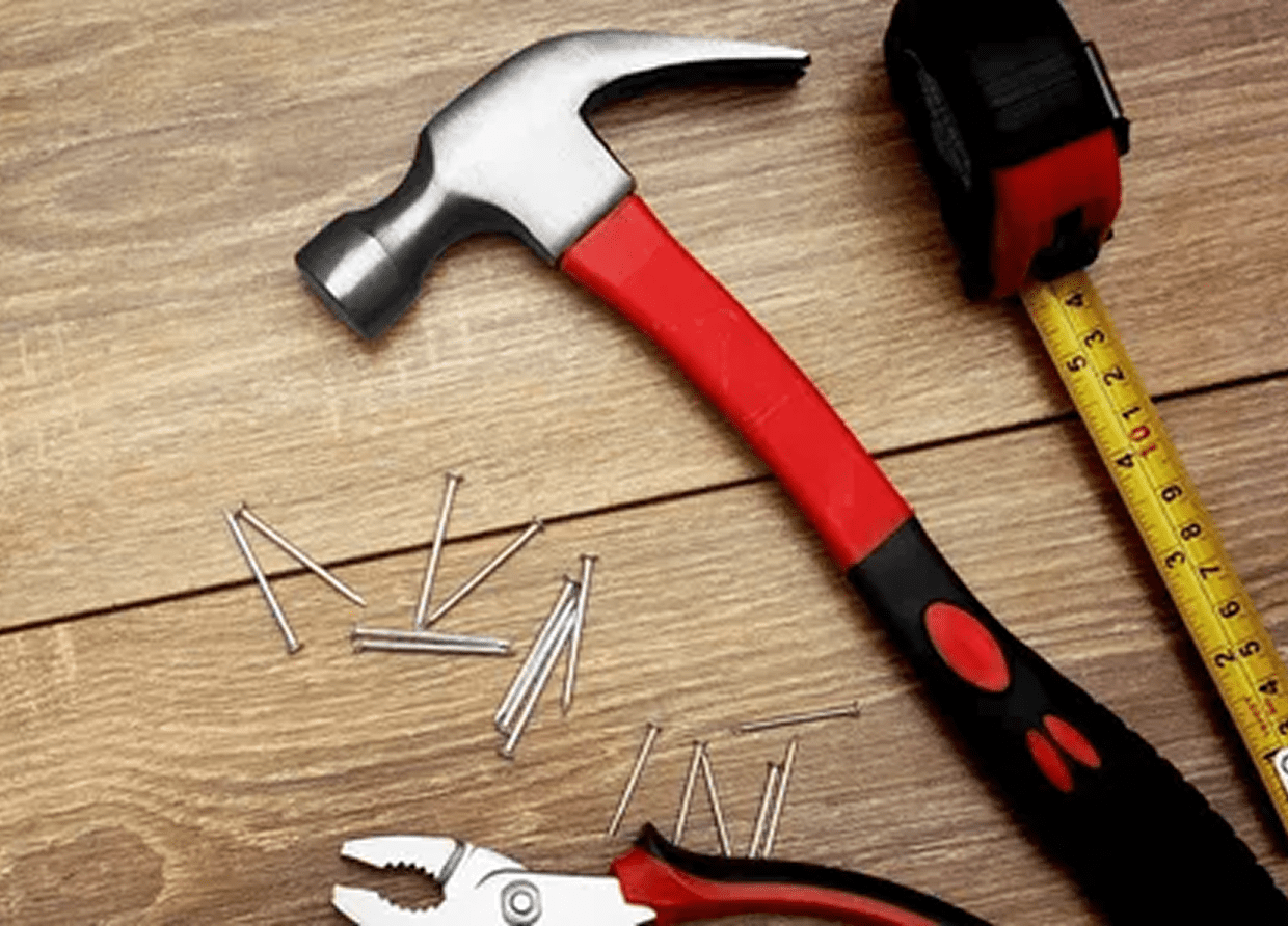 Carpenter tools on wooden background