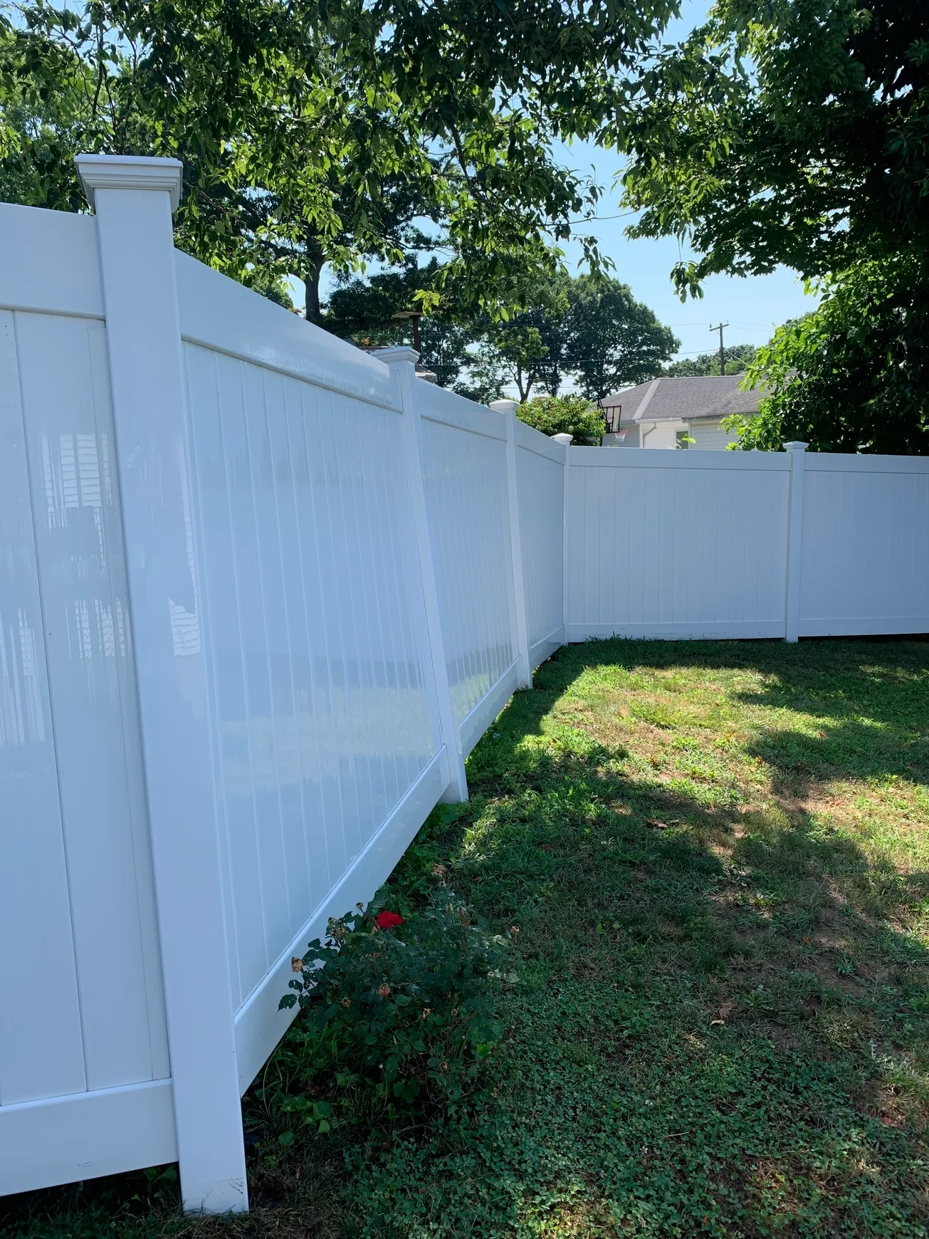 White vinyl fence with green grass